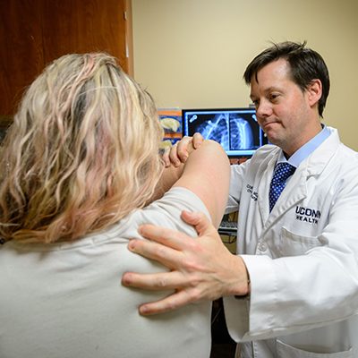 Doctor treating patient shoulder