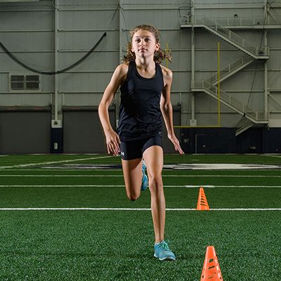 Woman of playing field running